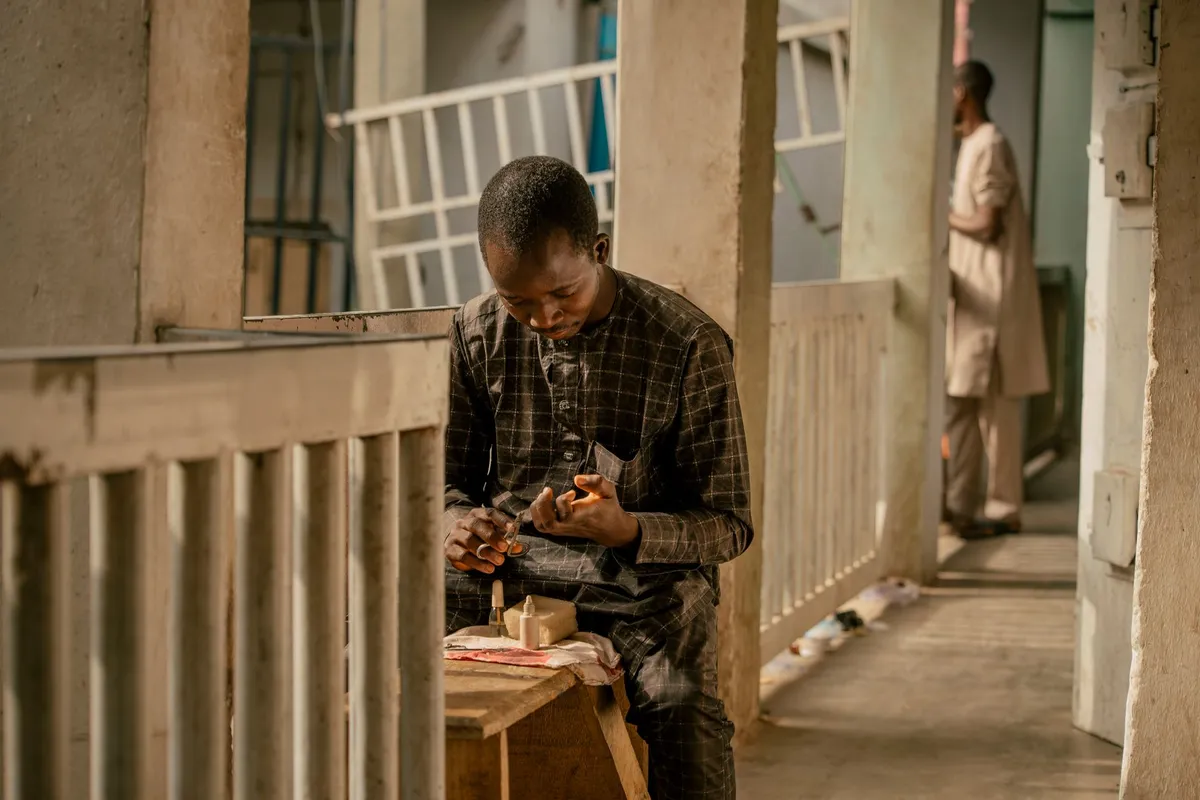 Panier en vannerie africaine contemporaine posé sur un meuble en bois clair dans un salon épuré parisien